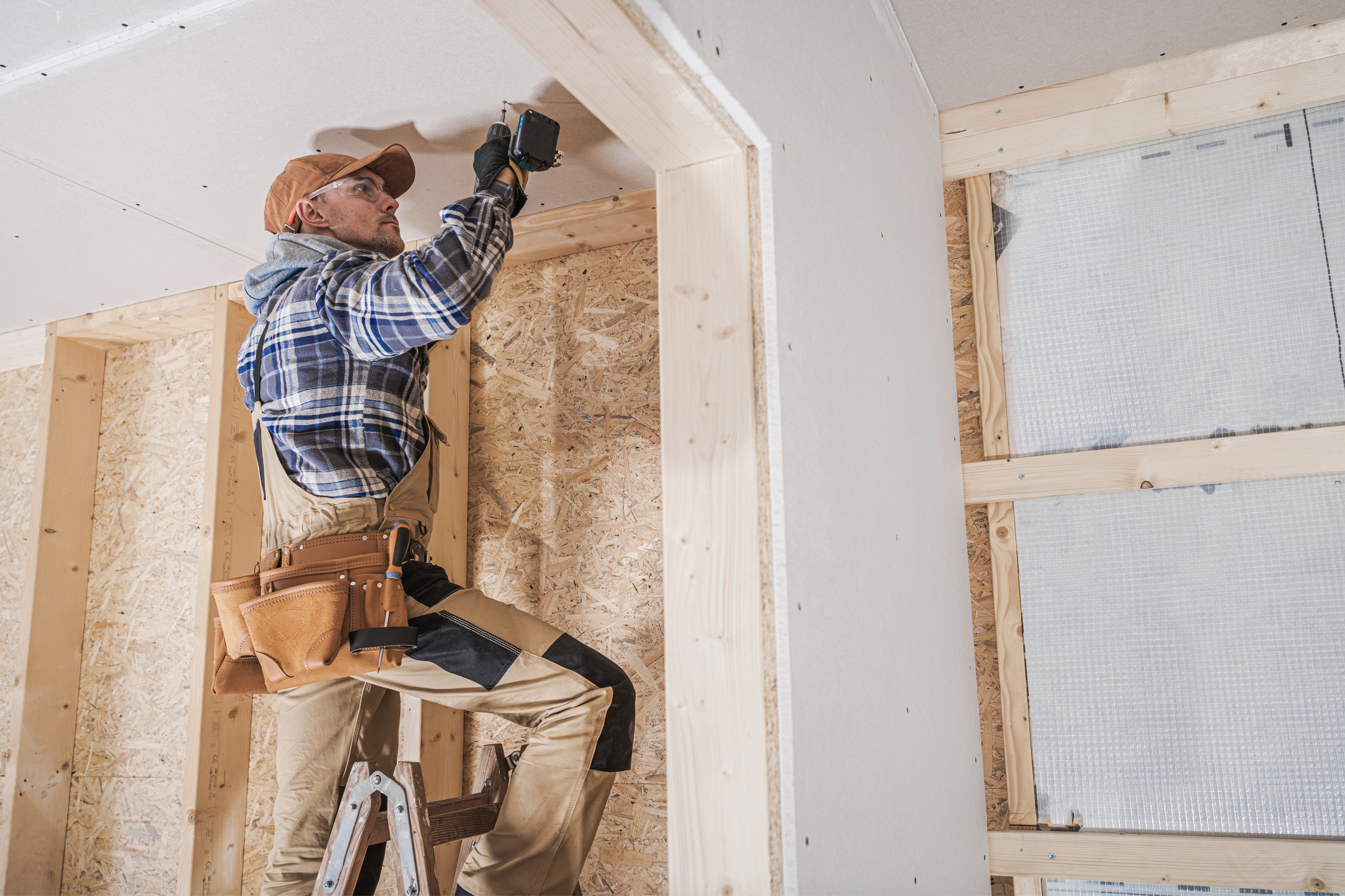 General Construction Contractor Worker Attaching Drywall Using D